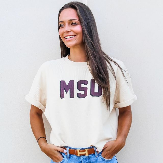 Girl in white MSU shirt